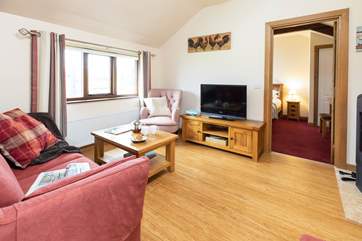 The comfortable living area looking through to the bedroom.