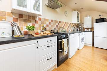 Welcome to the Shippon.
The well-equipped kitchen with door directly out to hot tub and private garden.