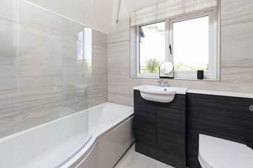 The family bathroom on the first floor has a bath with shower over, perfect for a soak after a busy day.