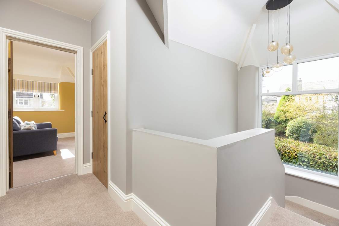 The turning staircase with feature light fitting.