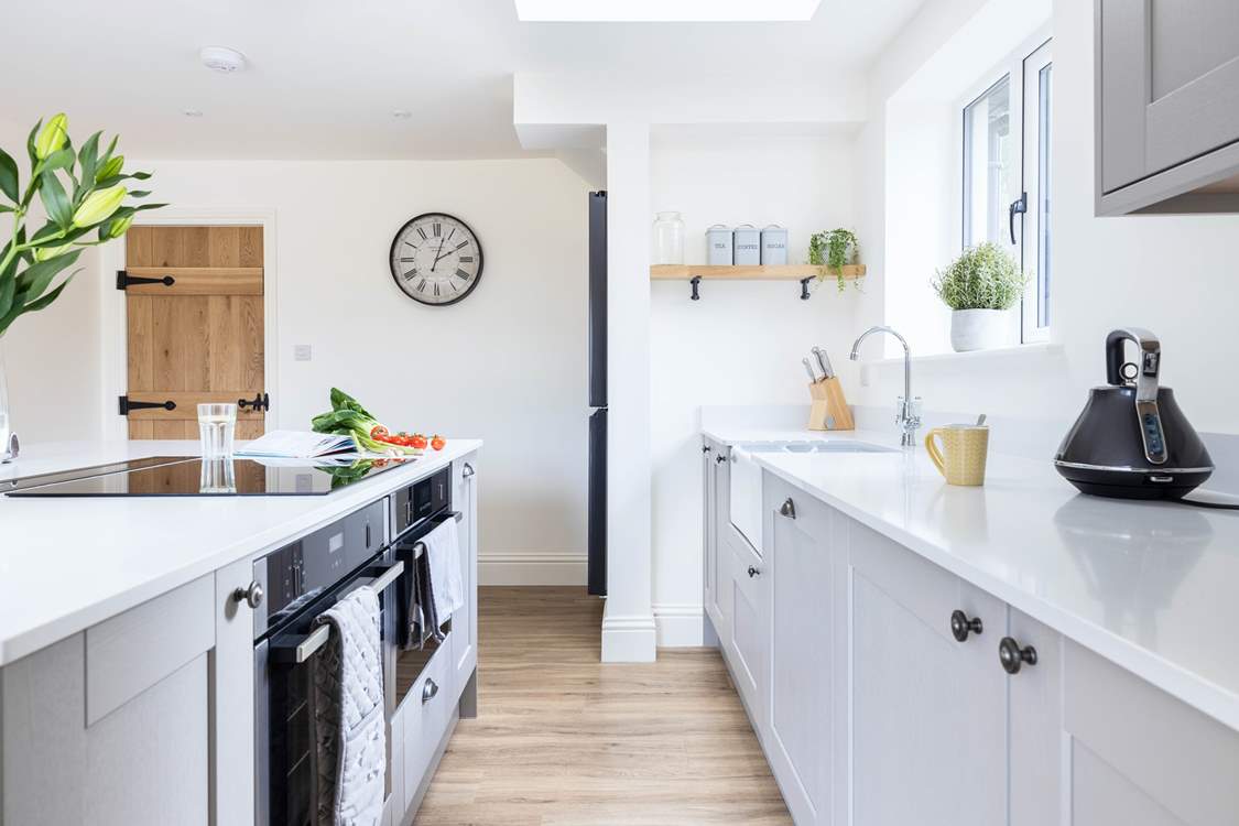 The super sleek kitchen has everything you need including a double oven and induction hob.