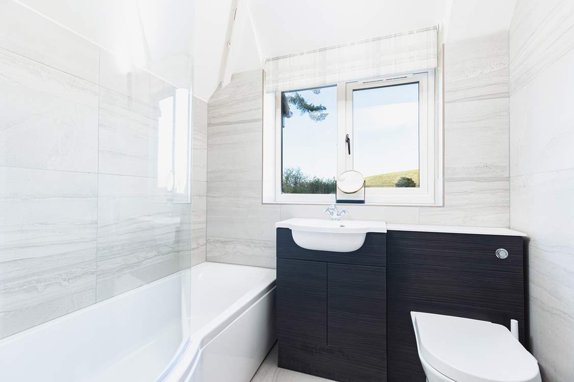 The family bathroom on the first floor has a bath with shower over, perfect for a soak after a busy day.