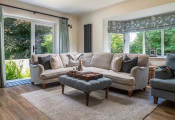 The grand sitting room is quite striking with plenty of comfy seating and natural light.