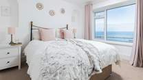Bedroom one is home to a super inviting king-size bed. Perfect for those lazy mornings in bed, soaking up the incredible views.