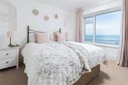 Bedroom one is home to a super inviting king-size bed. Perfect for those lazy mornings in bed, soaking up the incredible views.