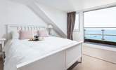 Bedroom three is home to this fabulous king-size bed, en suite and spectacular sea views, which can be enjoyed from your small balcony seating area. What a great spot to enjoy the morning paper. - Thumbnail Image