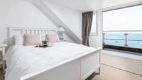 Bedroom three is home to this fabulous king-size bed, en suite and spectacular sea views, which can be enjoyed from your small balcony seating area. What a great spot to enjoy the morning paper.