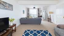 The sitting-room offers oodles of space and stunning sea views.