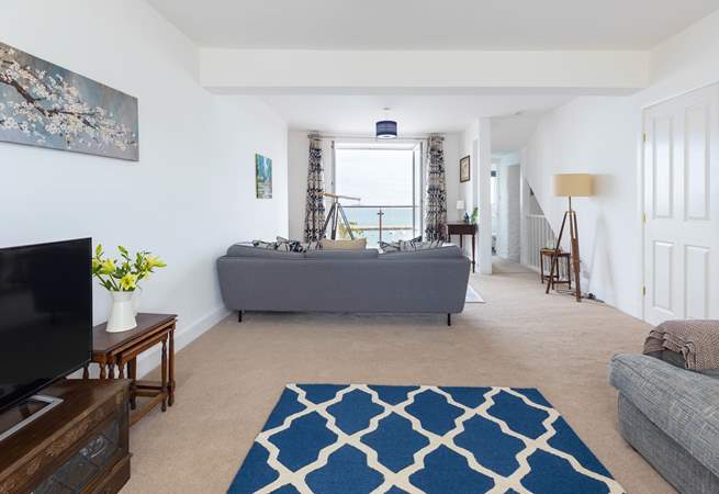 The sitting-room offers oodles of space and stunning sea views.