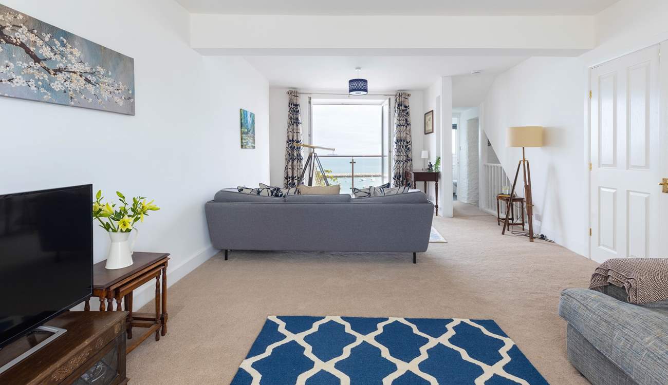 The sitting-room offers oodles of space and stunning sea views.