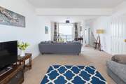 The sitting-room offers oodles of space and stunning sea views.