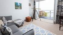 The sitting-room offers comfy seating to sit back and really soak up the view.