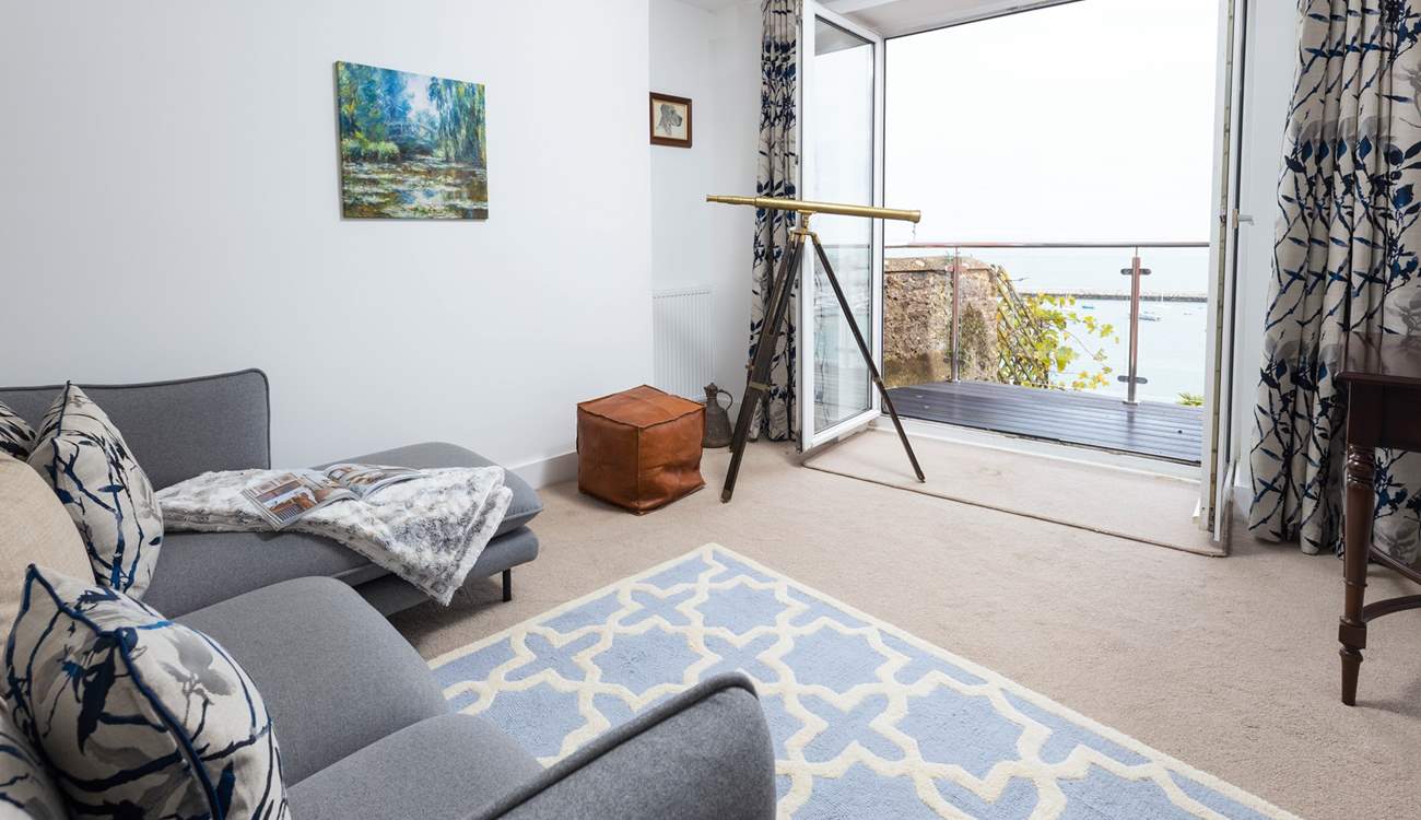 The sitting-room offers comfy seating to sit back and really soak up the view.