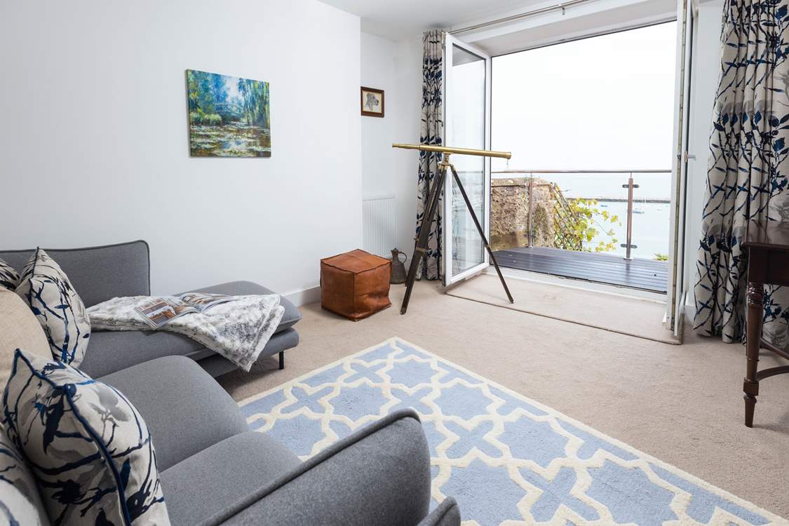 The sitting-room offers comfy seating to sit back and really soak up the view.