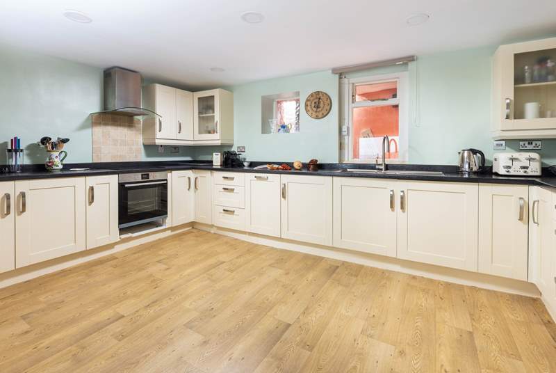 Venture down to the lower ground floor, and step into this rather spacious kitchen.