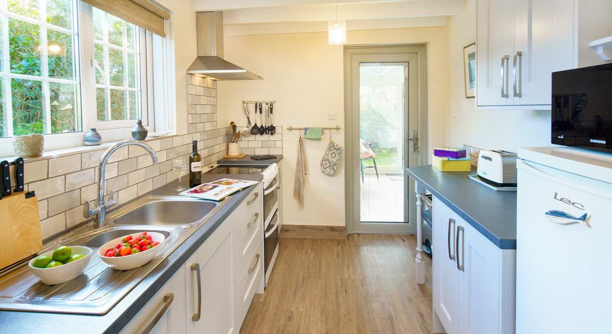 The well-equipped kitchen leads out to the garden-room.