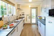 The light and airy kitchen leads out to the garden-room.