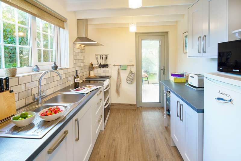 The well-equipped kitchen leads out to the garden-room.
