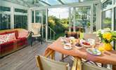 The sunny garden-room is the perfect spot for breakfast. - Thumbnail Image