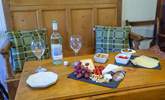 Sweet dining area decked with Welsh wool cushions. Dine in the glow of the cosy wood burner.  - Thumbnail Image