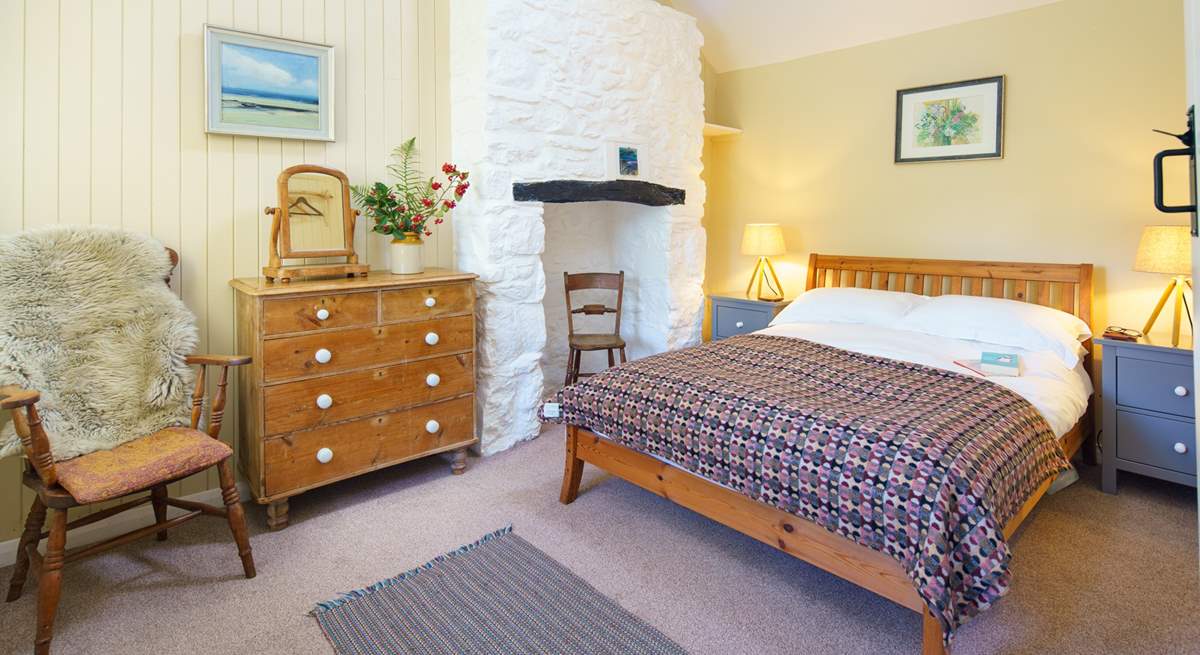 The charming double bedroom has a feature inglenook fireplace and exposed beams.