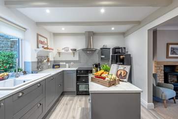 Guests can sit at the dining-table and watch meals being created in the kitchen.