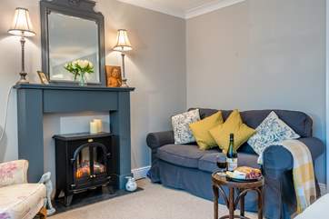 The log-effect electric fire adds warmth to the sitting area.