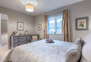 Bedroom 1 has a super-comfy king-size bed and is beautifully furnished in soft pastel shades.