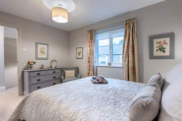 Bedroom 1 has a super-comfy king-size bed and is beautifully furnished in soft pastel shades.