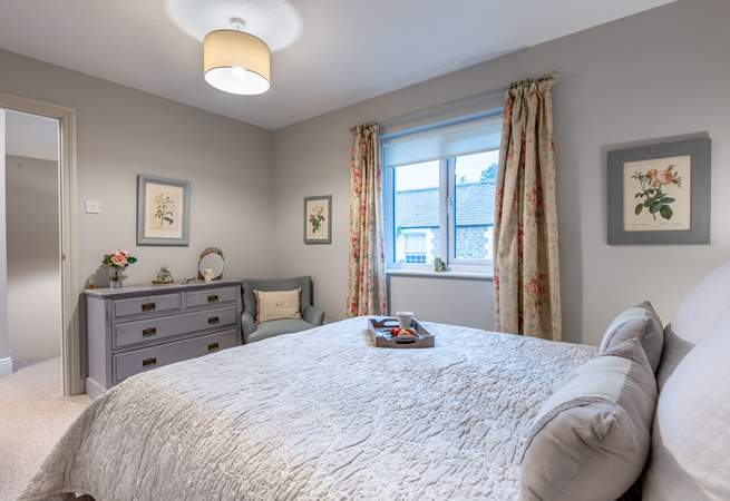 Bedroom 1 has a super-comfy king-size bed and is beautifully furnished in soft pastel shades.