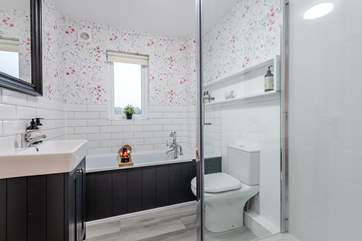 The family bathroom has a bath for a relaxing soak or a walk-in shower.