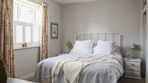 Bedroom 1 has calming tones.