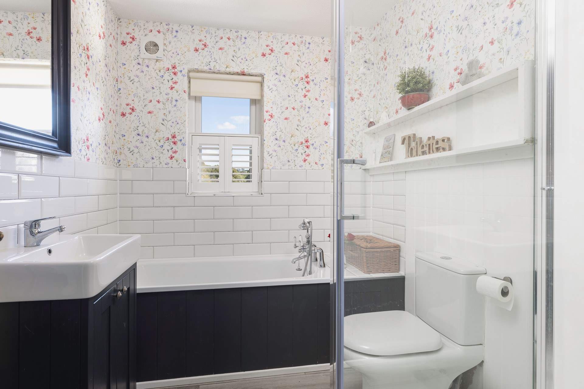 Relax in the family bathroom with bath and separate shower.