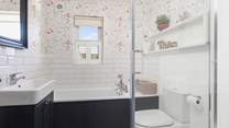 Relax in the family bathroom with bath and separate shower.