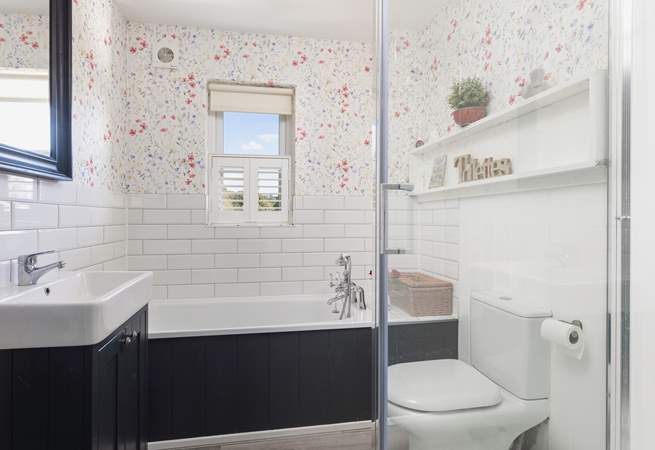 Relax in the family bathroom with bath and separate shower.
