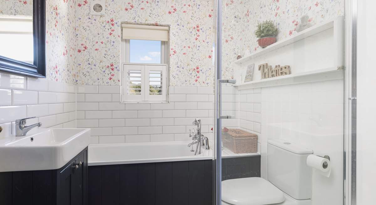 Relax in the family bathroom with bath and separate shower.