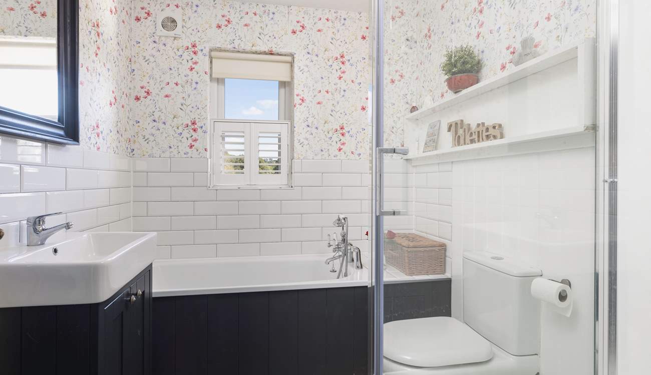 Relax in the family bathroom with bath and separate shower.