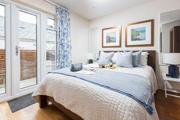Patio doors lead out from the bedroom to the decking area.
