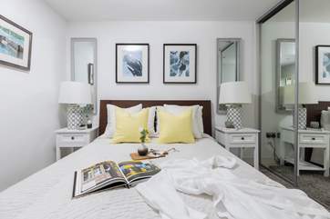 The bedroom is decorated in restful shades.
