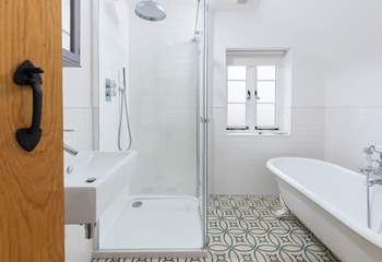 A large shower and roll-top bath make for a luxurious bathroom.