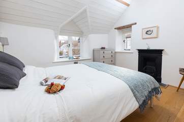 Gorgeous linen and character features await you in the main bedroom.