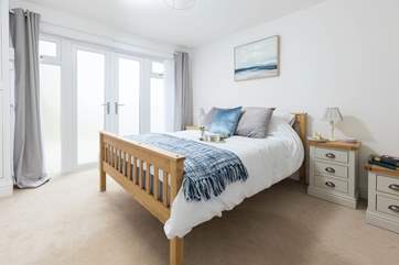 The bedroom is lovely and spacious.