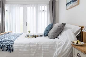 The calming bedroom has a king-size bed.