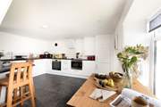 A choice of places to eat, perched at the breakfast-bar or around the dining-table.