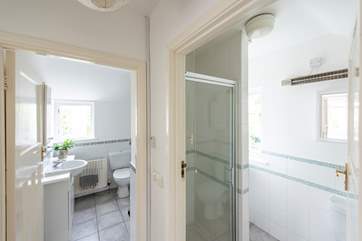 There is a shower-room next to the bathroom with a walk-in shower. Please note a step leads into this room.