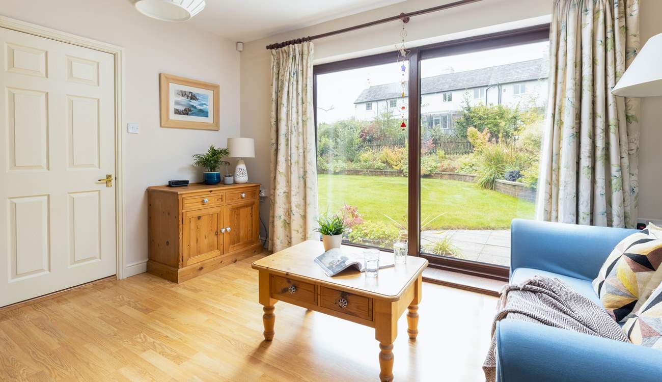 Step out of the snug area onto the beautiful patio and garden area beyond.