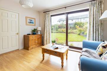 Step out of the snug area onto the beautiful patio and garden area beyond.