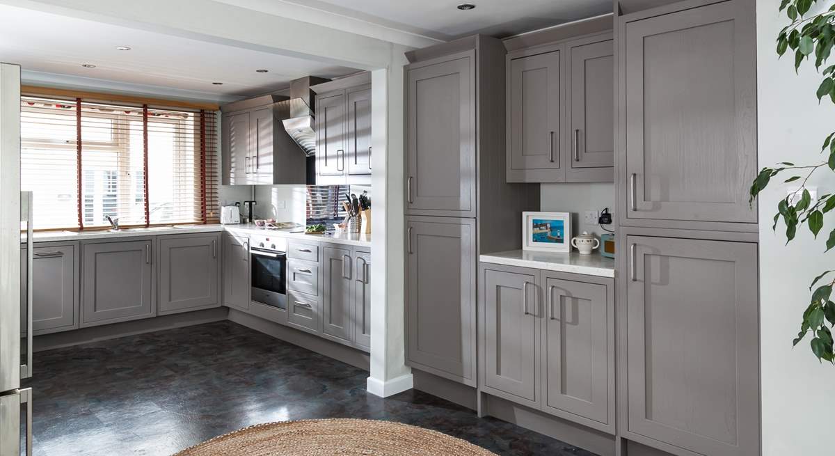 The open plan kitchen/diner is flooded with light. 