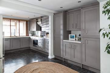 The open plan kitchen/diner is flooded with light.