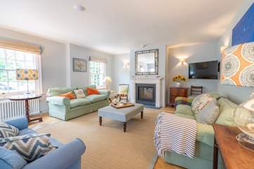 The welcoming sitting-room has the benefit of a wood-burner.